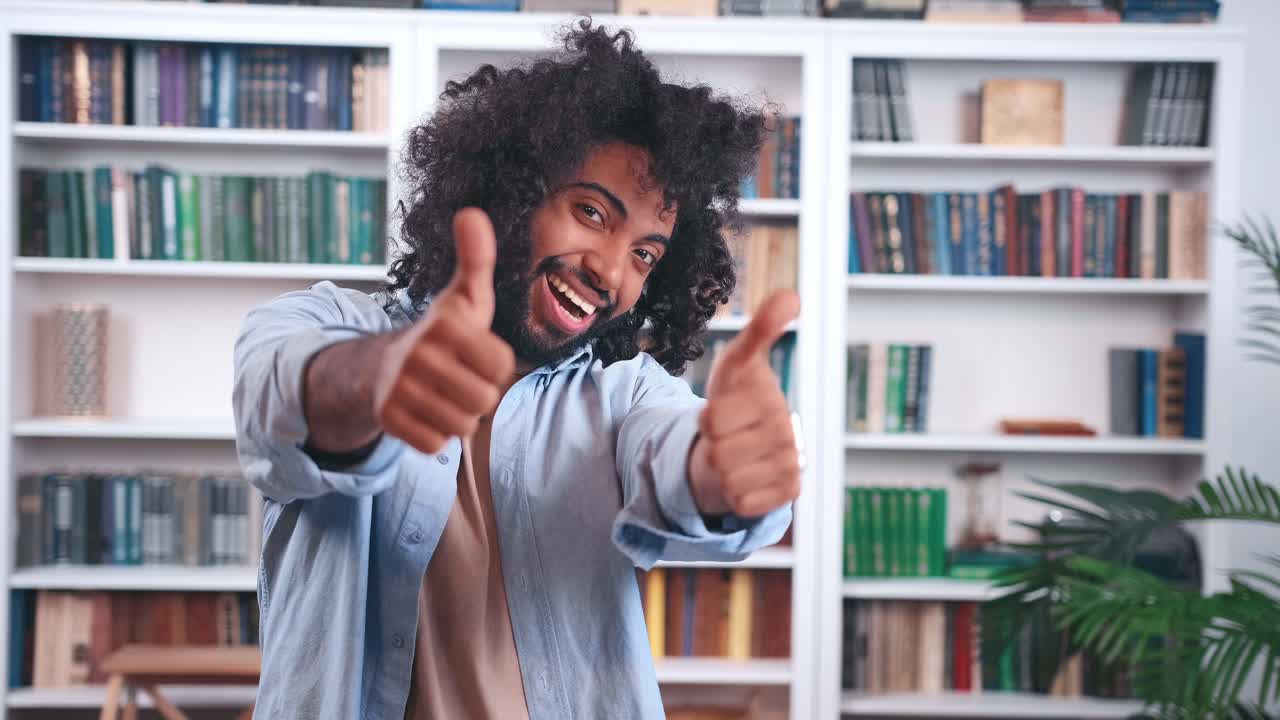 Cheerful young indian man office worker depicts simple dance making cool gesture