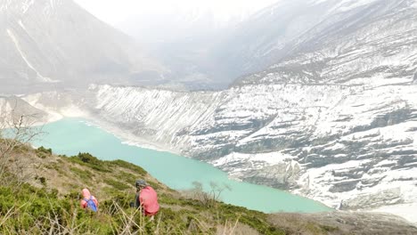 couple backpackers do acclimatization near lake birendra in nepal. manaslu area.