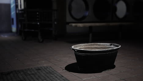 a bucket sitting on the ground in the dark