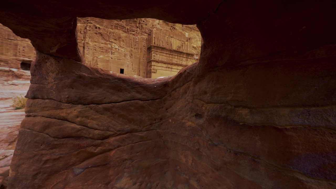 caminando a lo largo de las tumbas en petra cerca del tesoro, sitio histórico del patrimonio de la unesco tallado en piedra arenisca de roca roja en jordania. famoso lugar de filmación de la película indiana jones y destino turístico khaznet.