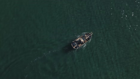 aerial view of fishing boat passing by shallow water