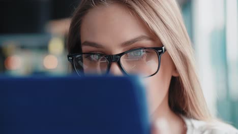 close up of focused woman using tablet in the office