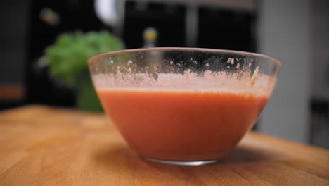el cocinero coge un bol de gazpacho