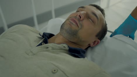 man sleeping on hospital bed