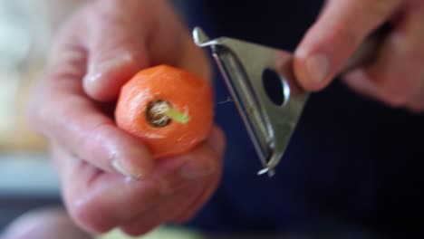 chef peeling carrot in slow motion