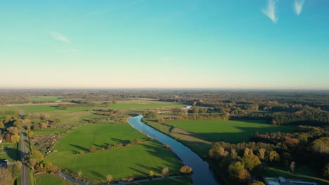 aerial view of a river winding through a dutch countryside landscape