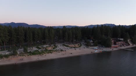 close-up panning shot of a lakefront beach in lake tahoe at low light