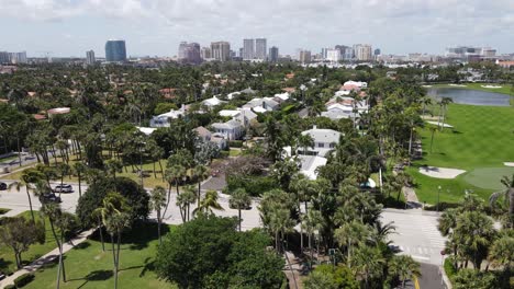 Gorgeous-aerial-of-Palm-Beach,-Florida-downtown-with-the-uber-wealthy-suburbs-and-splendid-golf-courses-below