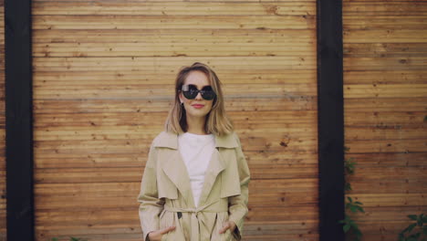 stylish woman in beige trench coat