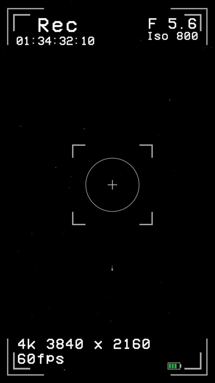 Vertical 9:16 modern camera viewfinder recording screen with 4k 60fps data, focus brackets, and battery icon. Clean ui for tech or social media content