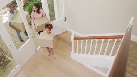 african american couple and their daughter moving into new house