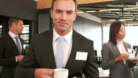 Smiling-businessman-drinking-coffee