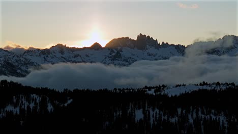 mammoth mountain ski resort minarets vista california aerial view drone valley fog inversion cloud moving jagged peak spring sunset rays ansel adams wilderness inyo forest devils postpile circle right