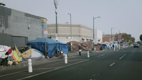 urban street with homeless encampment and tents