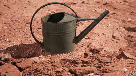 beverage can in sand and rocks desert