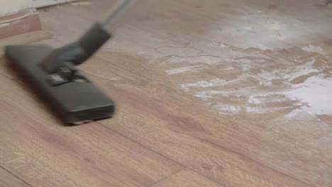 Hoovering-a-dirty-dusty-floor-with-an-electric-vacuum