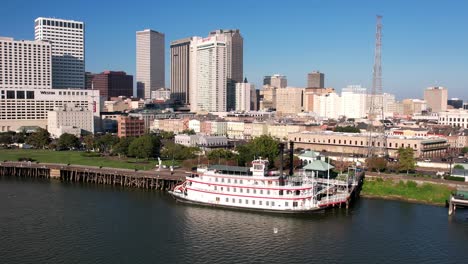 an aerial view of new orleans zooming out onto the mississippi river on a bright and sunny day