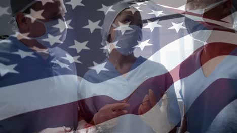 animation of flag of usa waving over surgeons in operating theatre