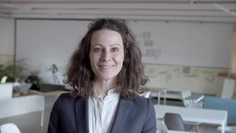 professional middle aged businesswoman smiling at camera