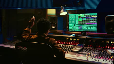 african american audio engineer counting down singer in sound booth