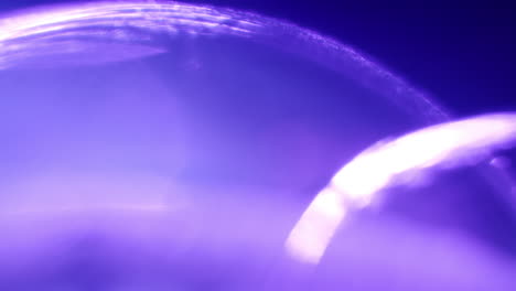 stream of particles on the surface of a purple sphere