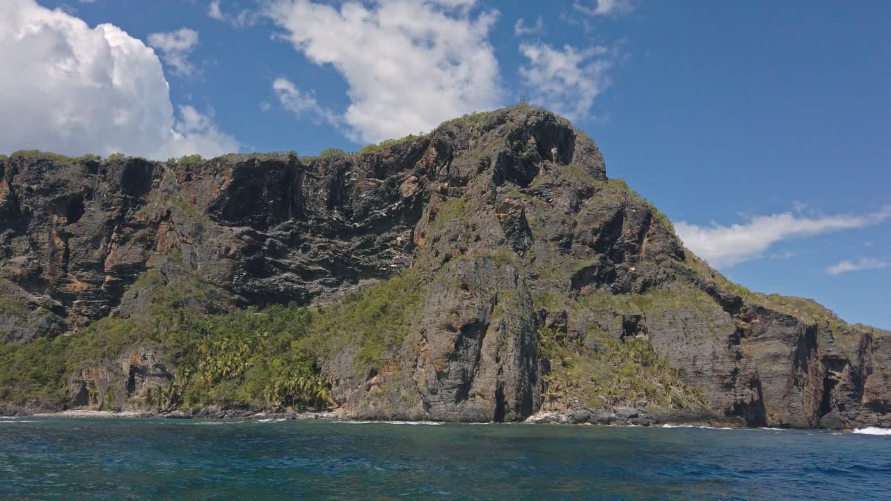 Sightseeing on boat with Playa Fronton beach and cliff in background, Las Galeras in Dominican Republic