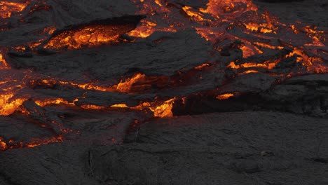 incredible view of masses of earth moving as river stream of glowing lava flows