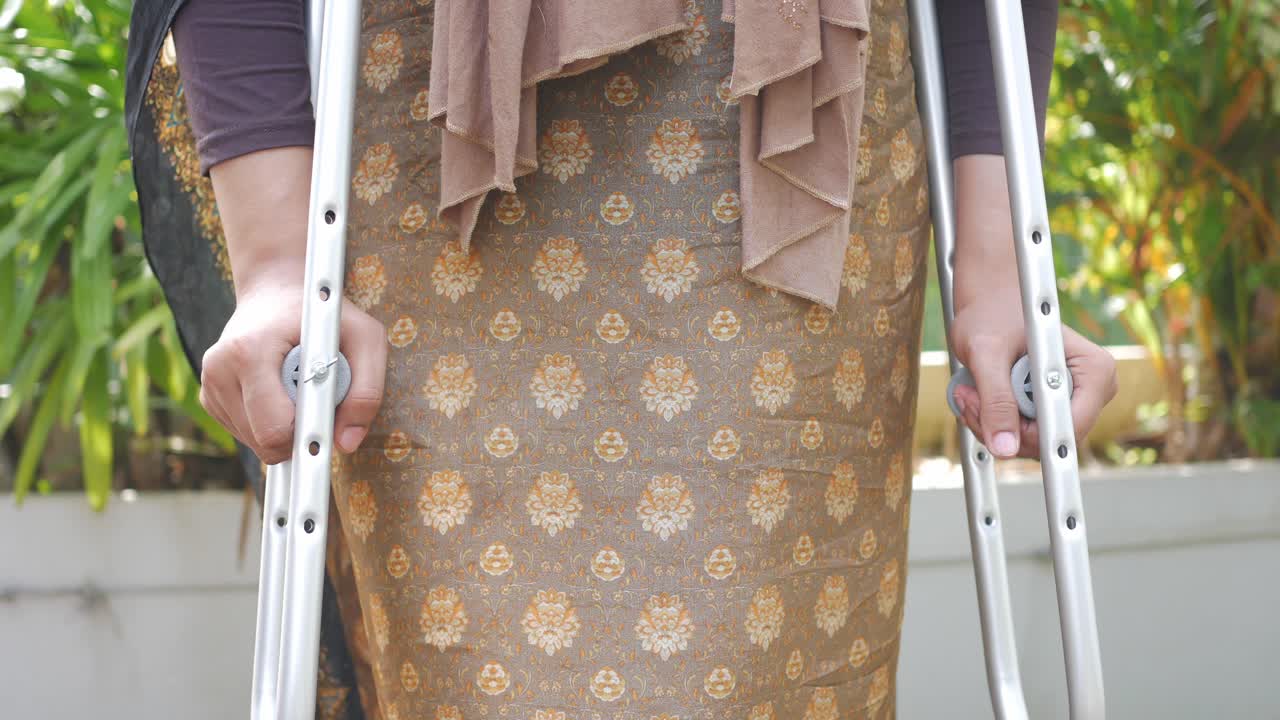 Woman using crutches