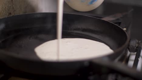 pouring mix on plate making enjera yemeni style ethiopian pan cooking