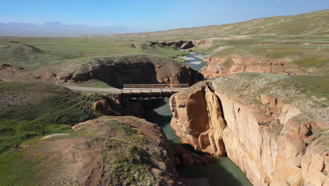 Epic-cinematic-revealing-drone-shot-of-the-ravine-and-river-near-the-Kel-Suu-lake-in-Kyrgyzstan