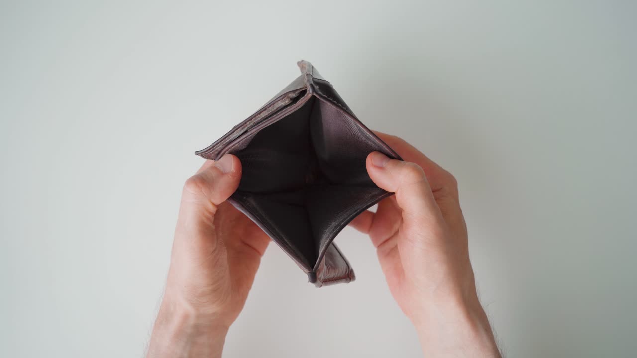Man opening an empty wallet. Poverty