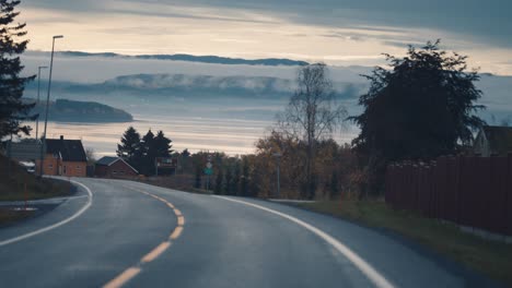 a country road follows the fjord coastline