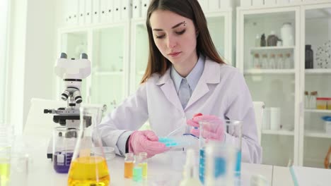 a young female scientist conducting an experiment in a laboratory