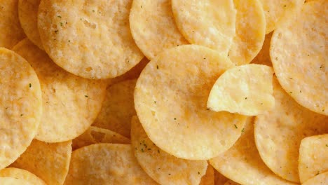 background and texture of a heap of rotating potato chips.