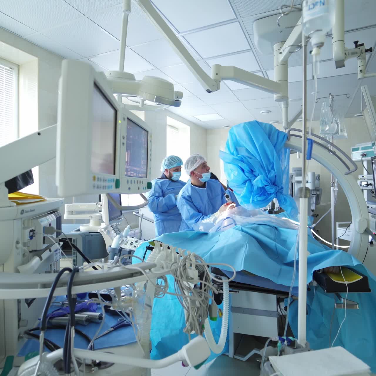 Doctors during surgery in hospital. Cooperative multi age team of doctors perform surgical procedure