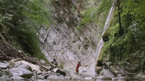 waterfall in a canyon with hikers