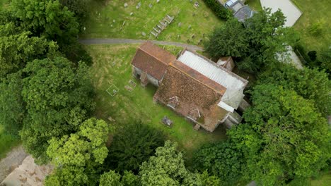 a top-down arc shot of all saints church in west stourmouth