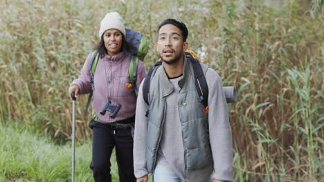 talking, pointing and a hiking couple in nature