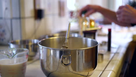 a chef reading a recipe and measuring ingredients while baking a vegan chocolate cake dessert on a kitchen counter