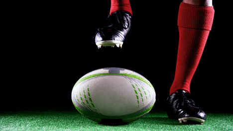 professional rugby sportsman put his foot on the ball