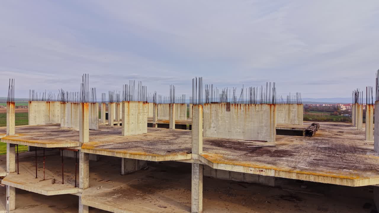 Construction site view of a partially built structure in an open landscape
