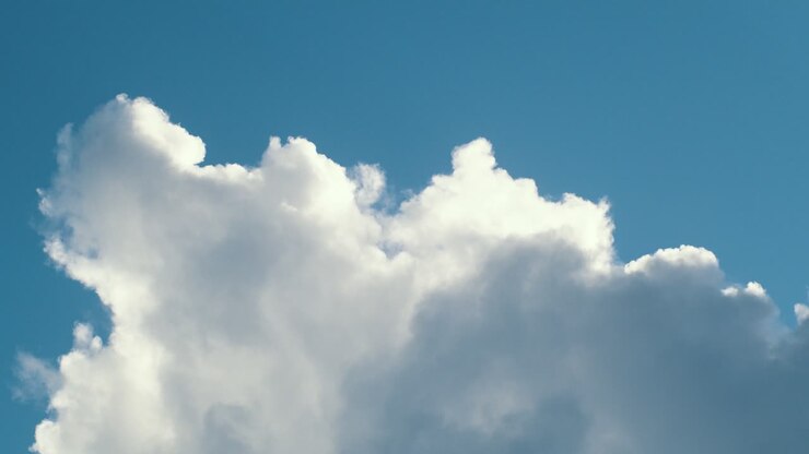 Static shot of rain clouds passing overhead on a sunny day