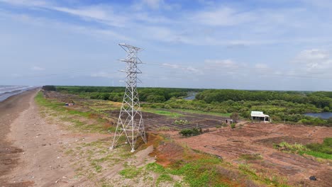 aerial view tilt of the transmission tower and the farm in ben tre.