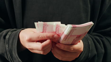 person holding stacks of russian rubles