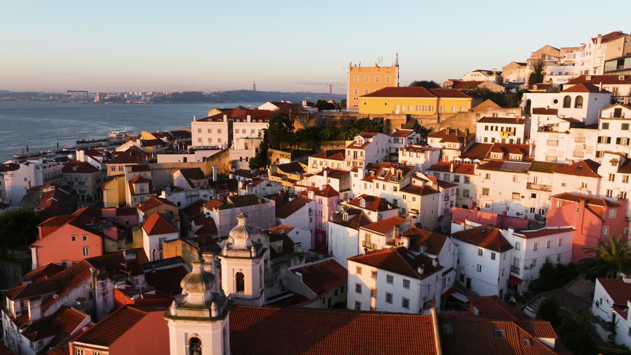 Tram lines and tiled roofs in Lisbon at dawn