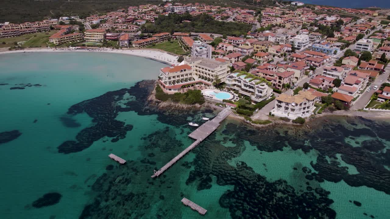 Aerial view of coastal city with pier, Tyrrhenian sea tropical bay, Sardinia