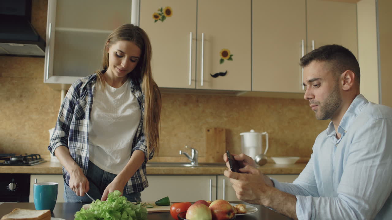 Couple Cooking Together and Taking a Photo of the Food