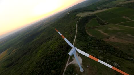 fpv aerial shot of wind turbine, renewable energy production for green ecological world