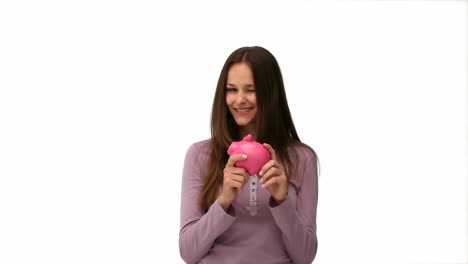 woman putting money into a moneybox
