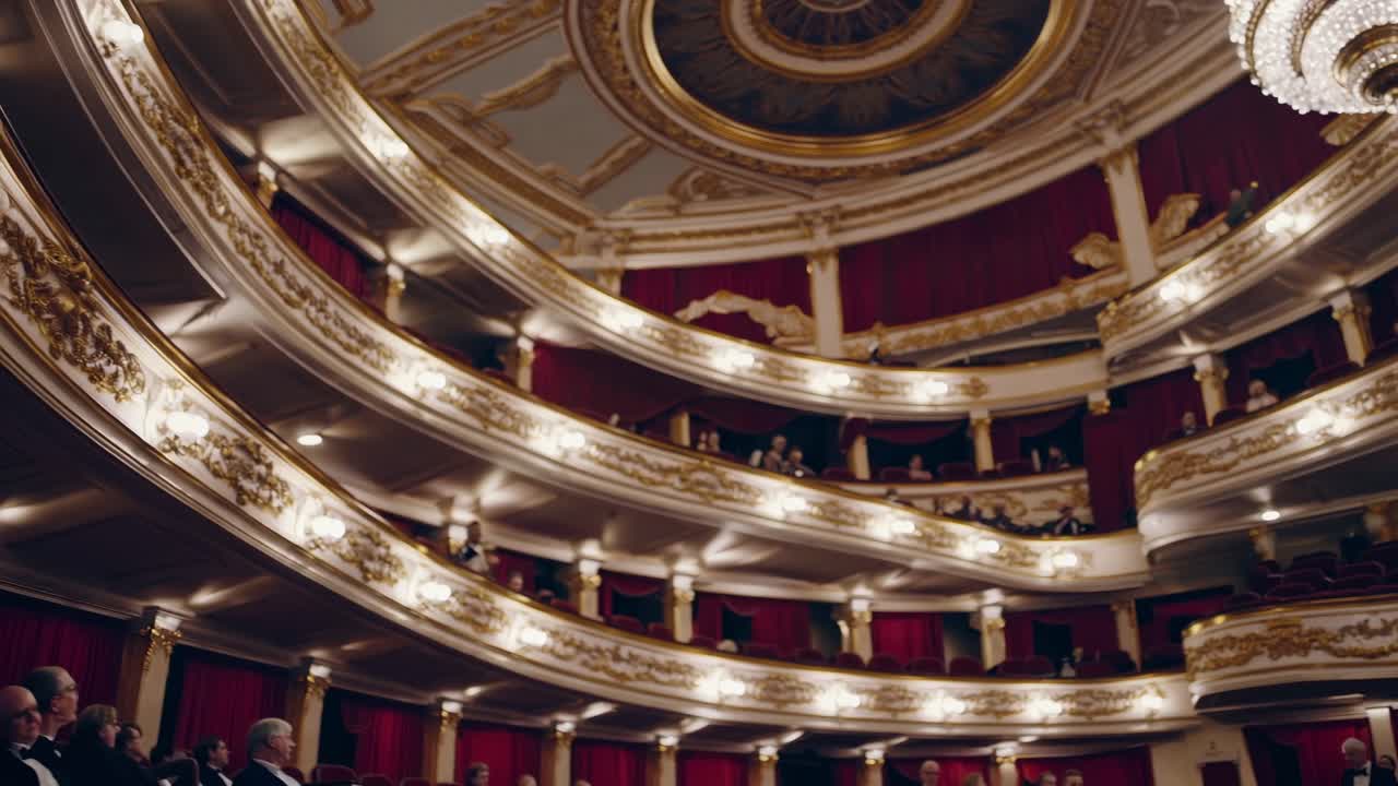 Elegant theater balconies filled with spectators enjoying an opera performance, showcasing the ornate architecture and rich atmosphere of a cultural venue